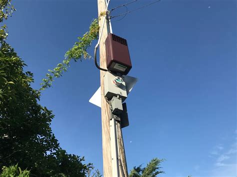 steel box on pole on side of road|mysterious boxes on poles.